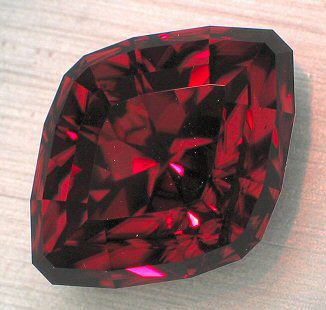 color shifting red zircon faceted by a master